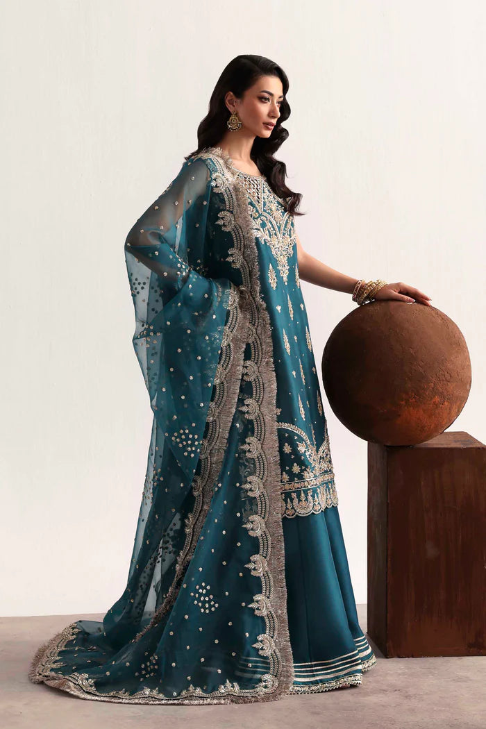 Luxury silk suit featuring hand-embroidered front, back, and sleeves, dyed silk trouser with organza border, and a 3-yard embroidered organza dupatta ensemble.