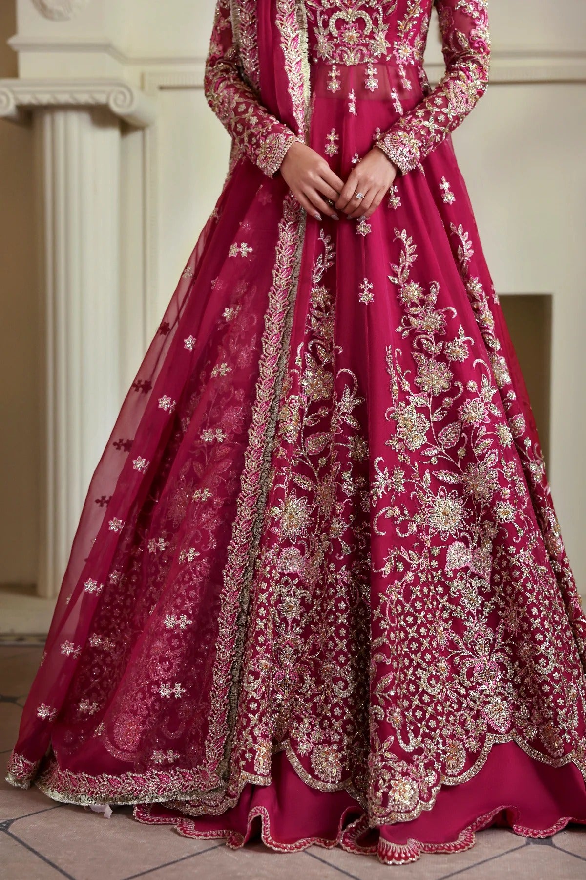 Opulent organza ensemble with hand-embellished panels, embroidered dupatta, lehenga border, Russian grip inner, and raw silk lehenga fabric. Ideal for events.