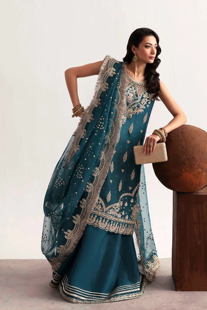Luxury silk suit featuring hand-embroidered front, back, and sleeves, dyed silk trouser with organza border, and a 3-yard embroidered organza dupatta ensemble.