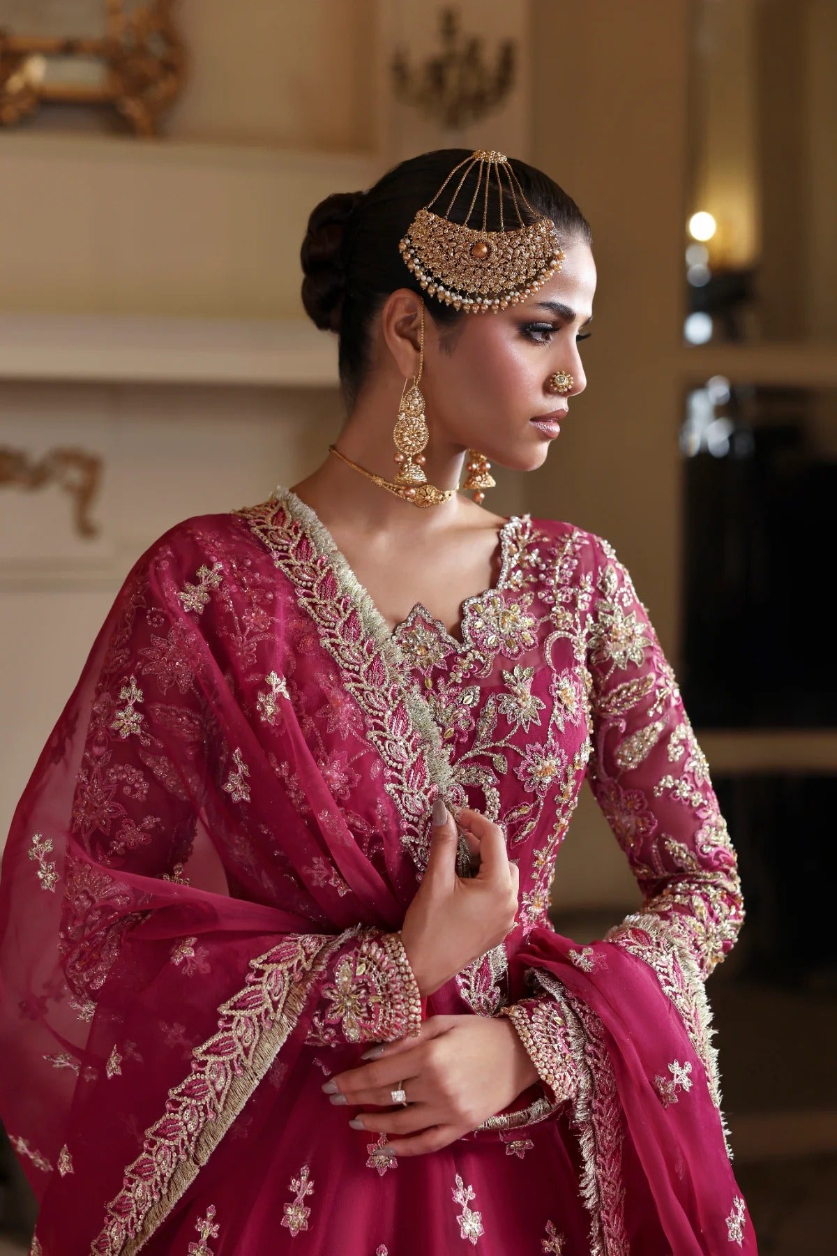 Opulent organza ensemble with hand-embellished panels, embroidered dupatta, lehenga border, Russian grip inner, and raw silk lehenga fabric. Ideal for events.