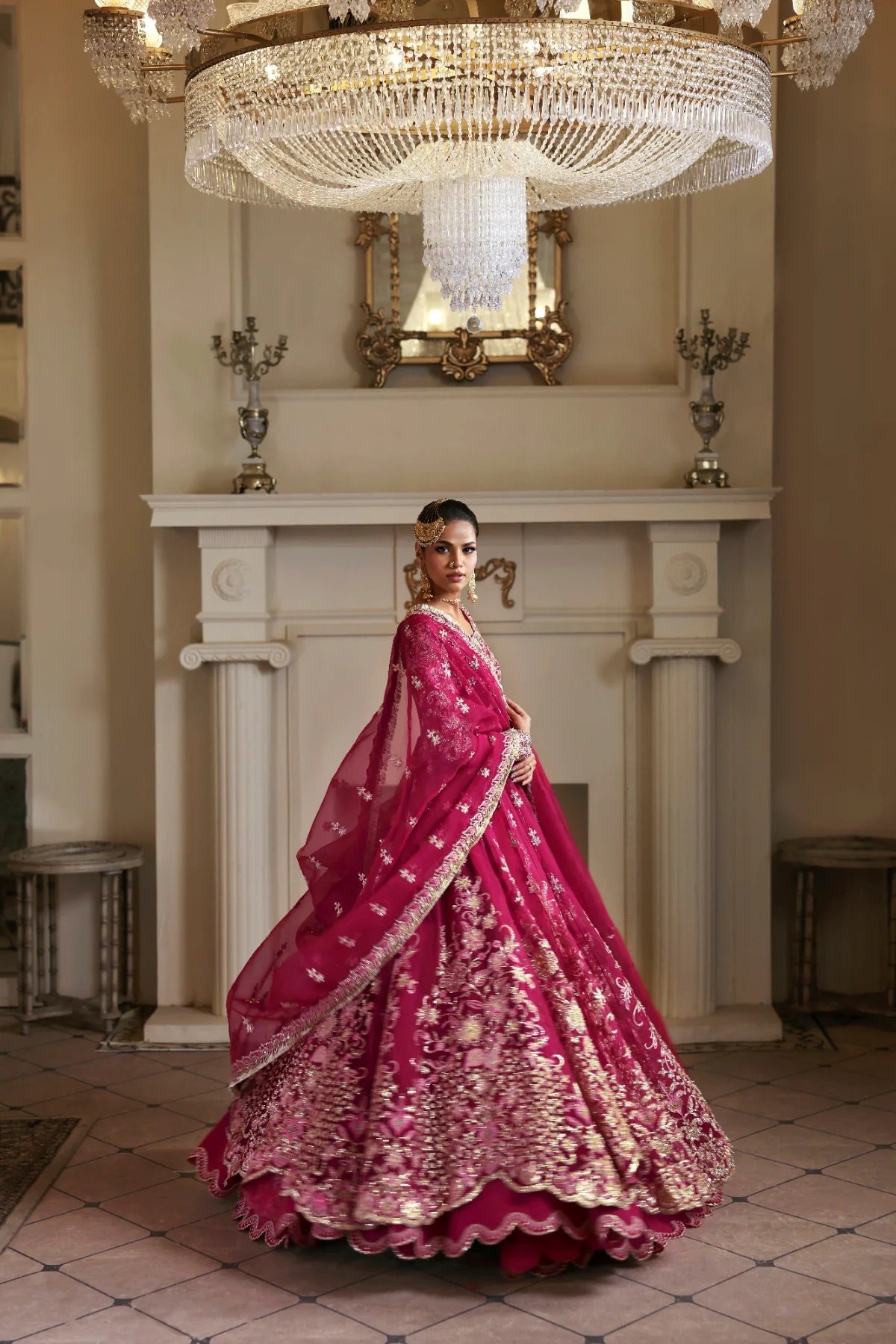 Opulent organza ensemble with hand-embellished panels, embroidered dupatta, lehenga border, Russian grip inner, and raw silk lehenga fabric. Ideal for events.