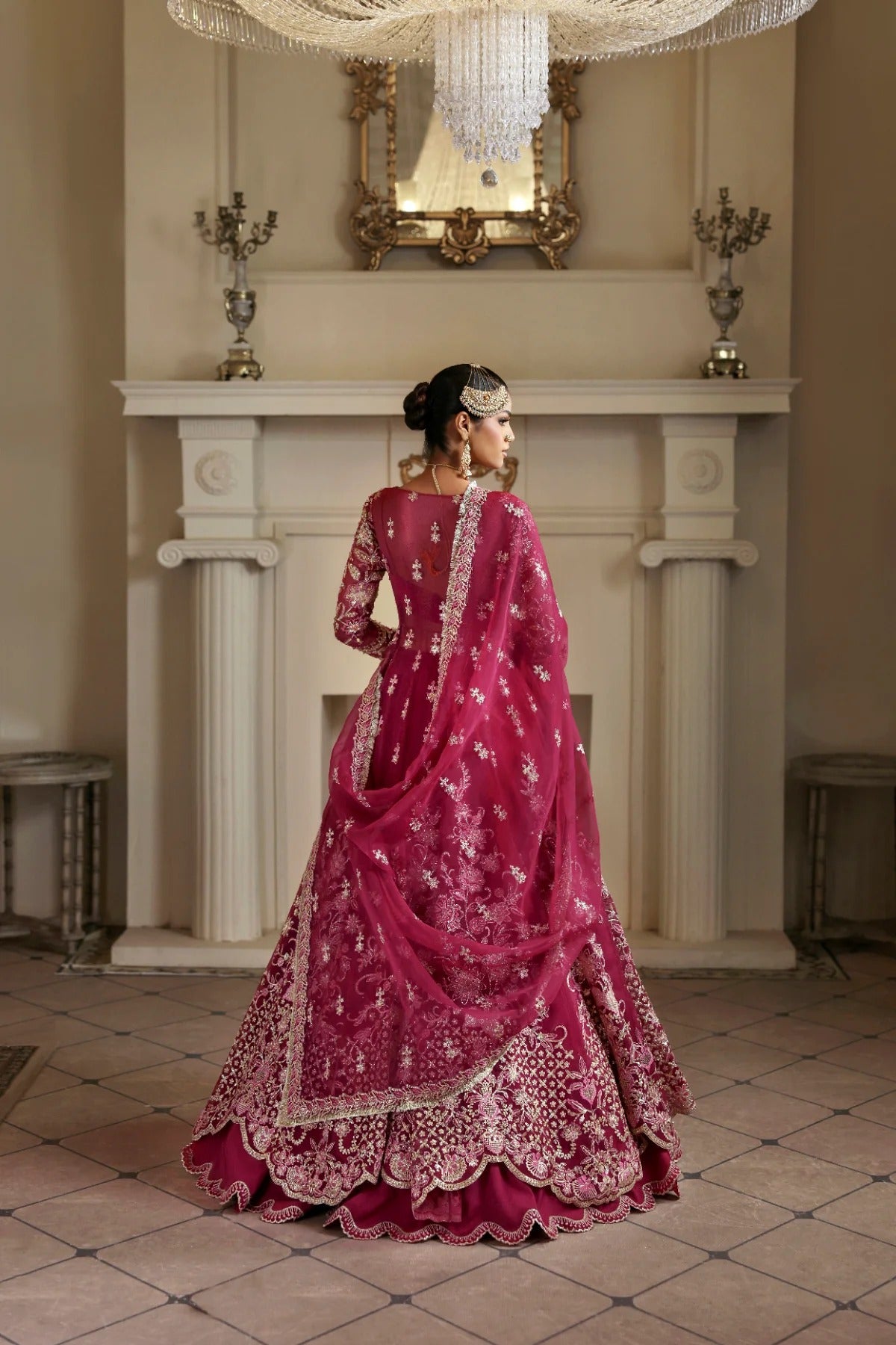 Opulent organza ensemble with hand-embellished panels, embroidered dupatta, lehenga border, Russian grip inner, and raw silk lehenga fabric. Ideal for events.