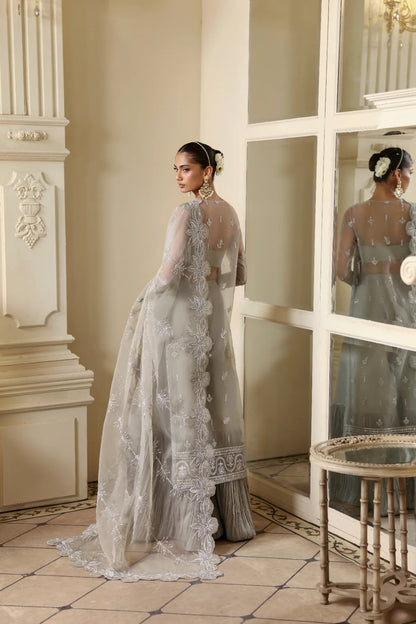 Elegant organza outfit with hand-embellished front, sleeves, and borders. Comes with embroidered dupatta, Russian grip inner, and 6 yards of raw silk trouser.