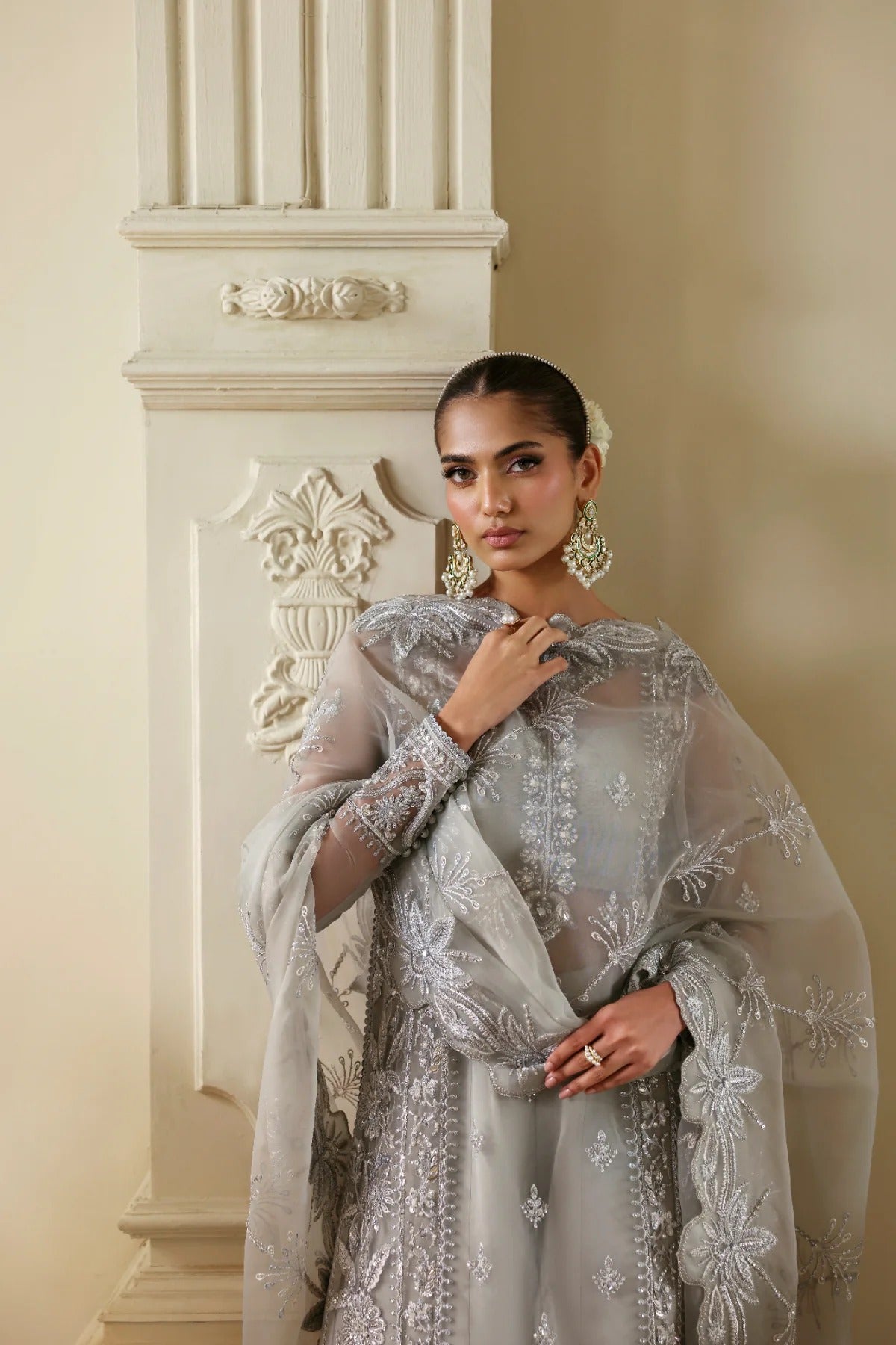 Elegant organza outfit with hand-embellished front, sleeves, and borders. Comes with embroidered dupatta, Russian grip inner, and 6 yards of raw silk trouser.