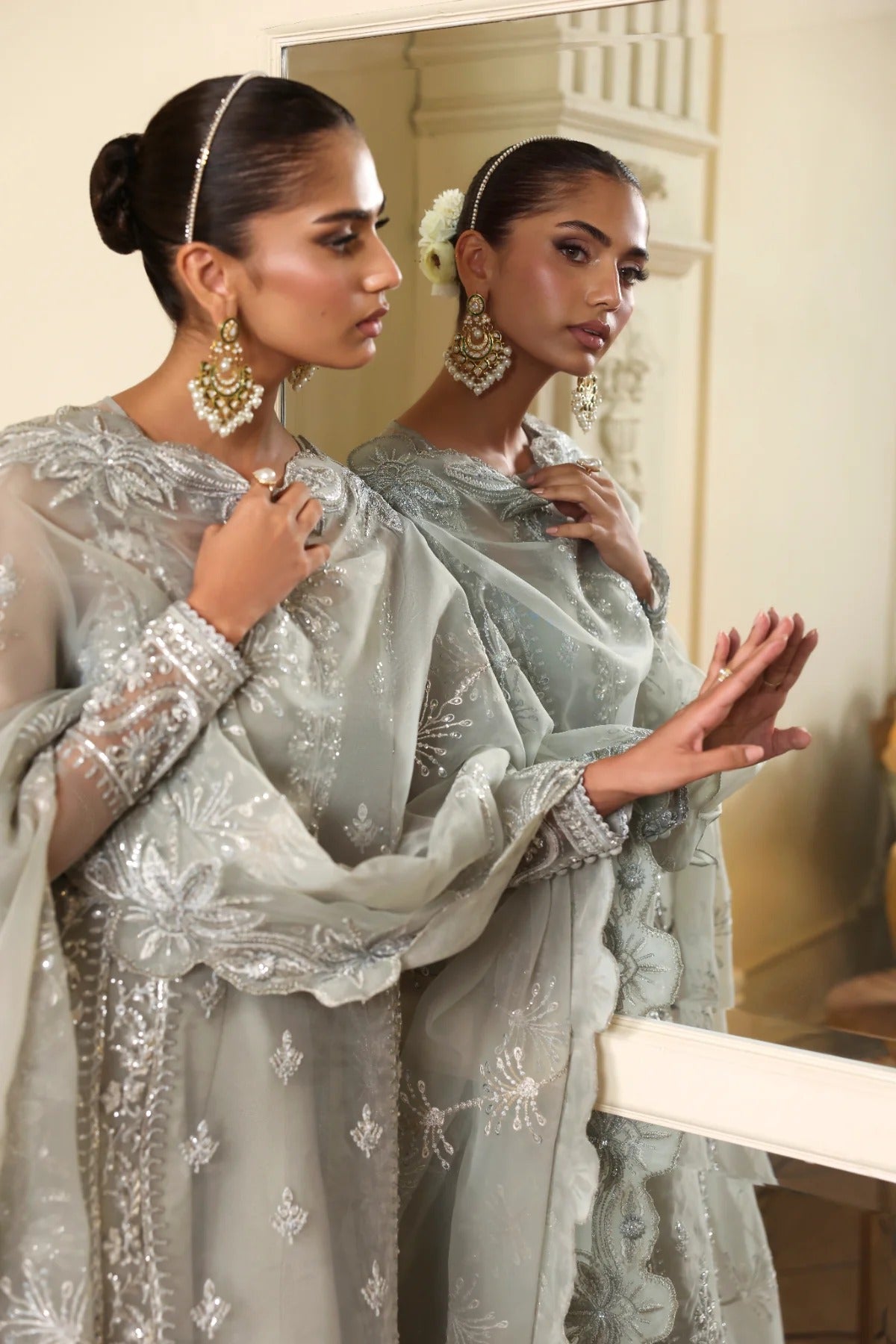 Elegant organza outfit with hand-embellished front, sleeves, and borders. Comes with embroidered dupatta, Russian grip inner, and 6 yards of raw silk trouser.