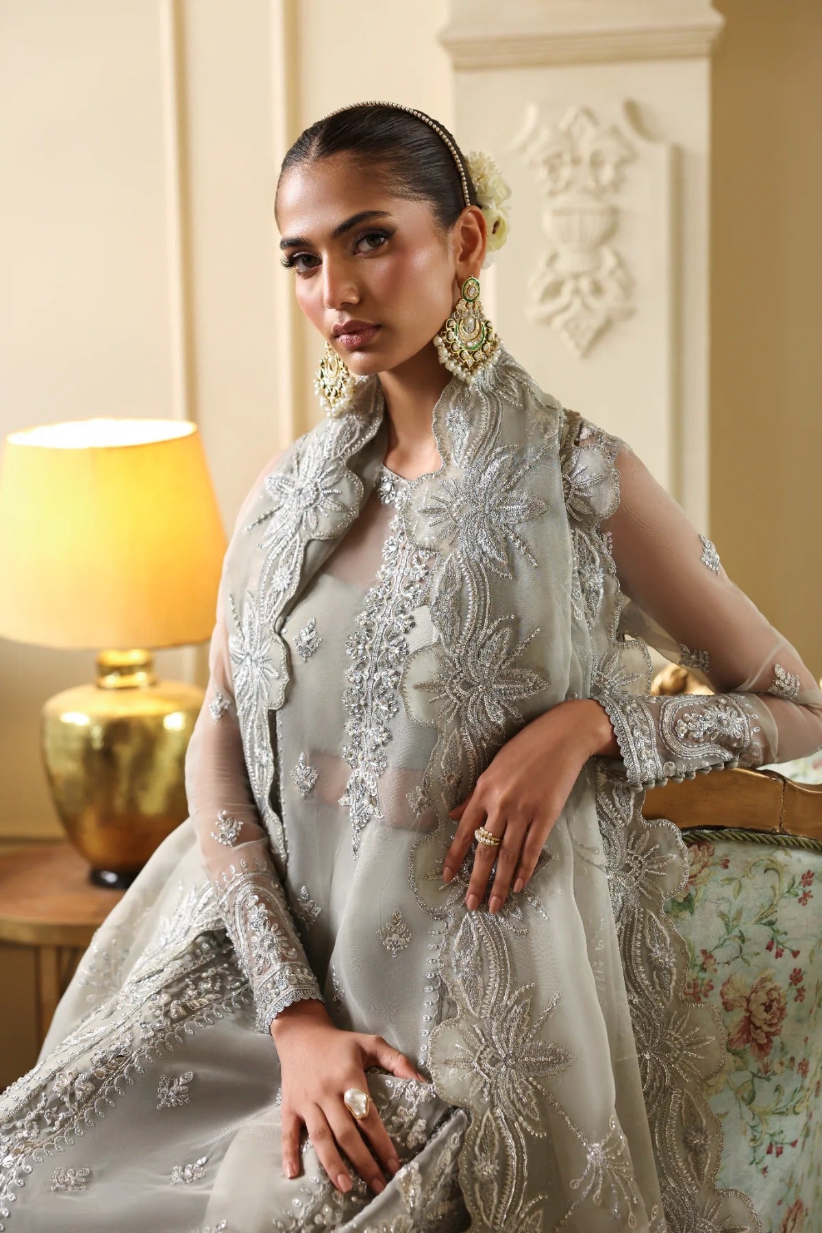 Elegant organza outfit with hand-embellished front, sleeves, and borders. Comes with embroidered dupatta, Russian grip inner, and 6 yards of raw silk trouser.