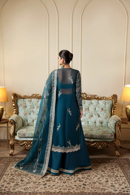 Refined organza dress with hand-embellished panels, sleeves, and borders. Includes embroidered dupatta, Russian grip inner, and raw silk trouser fabric.