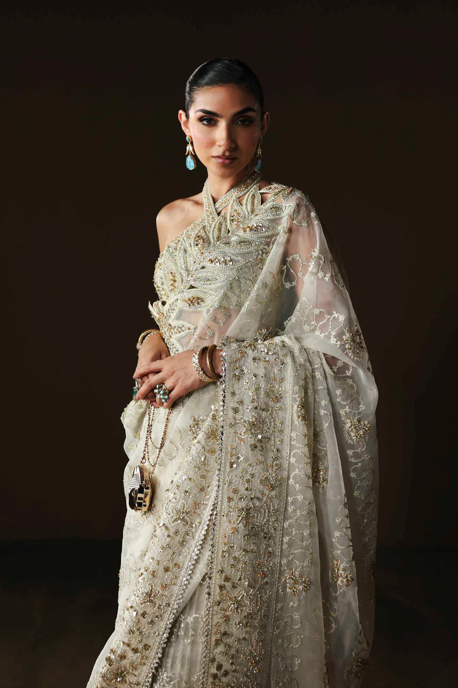 Shop luxury organza embroidered saree with hand embellished blouse, pallu & borders. Includes raw silk inner—perfect for weddings & festive wear.