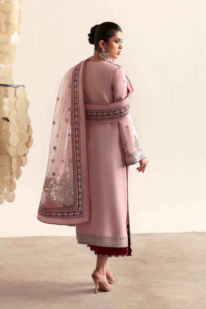 Elegant silk suit featuring hand-embroidered front, back, and sleeves, dyed silk trouser, and a 3-yard organza dupatta with embroidered borders and motifs.