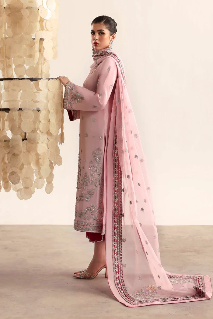 Elegant silk suit featuring hand-embroidered front, back, and sleeves, dyed silk trouser, and a 3-yard organza dupatta with embroidered borders and motifs.