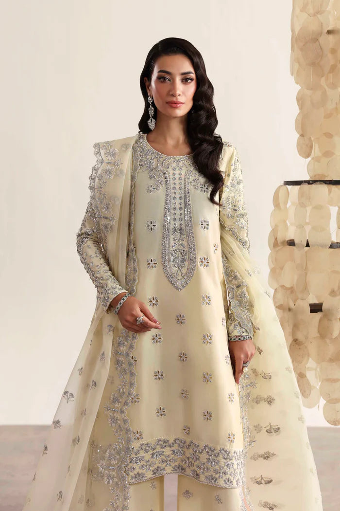 Luxury silk suit featuring hand-embroidered front, back, and sleeves, matching embroidered trouser, organza dupatta, and delicate organza motifs for a complete ensemble.