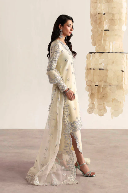 Luxury silk suit featuring hand-embroidered front, back, and sleeves, matching embroidered trouser, organza dupatta, and delicate organza motifs for a complete ensemble.
