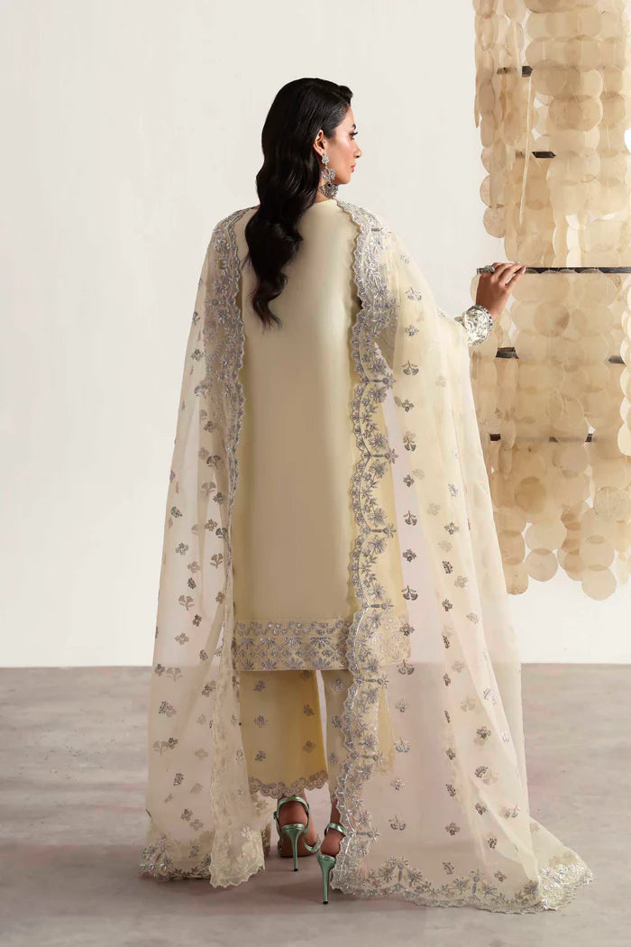 Luxury silk suit featuring hand-embroidered front, back, and sleeves, matching embroidered trouser, organza dupatta, and delicate organza motifs for a complete ensemble.