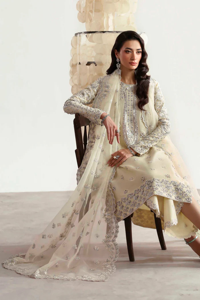 Luxury silk suit featuring hand-embroidered front, back, and sleeves, matching embroidered trouser, organza dupatta, and delicate organza motifs for a complete ensemble.