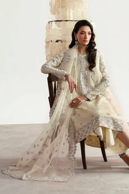 Luxury silk suit featuring hand-embroidered front, back, and sleeves, matching embroidered trouser, organza dupatta, and delicate organza motifs for a complete ensemble.
