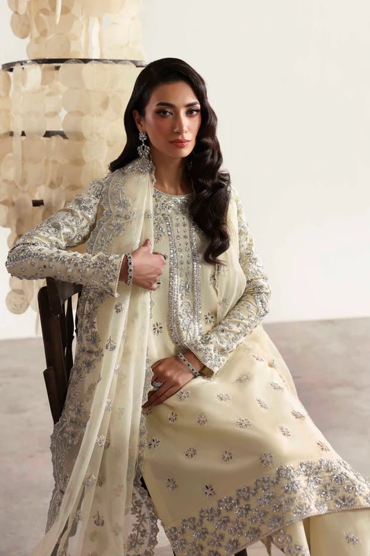 Luxury silk suit featuring hand-embroidered front, back, and sleeves, matching embroidered trouser, organza dupatta, and delicate organza motifs for a complete ensemble.