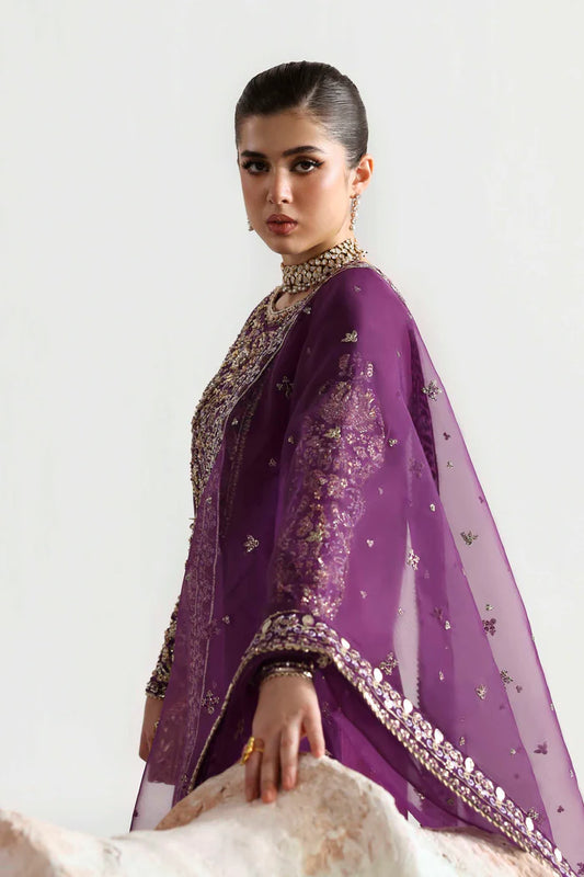 Elegant silk suit featuring hand-embellished embroidered front, dyed silk back, detailed sleeves, matching embroidered trouser, and an organza dupatta.