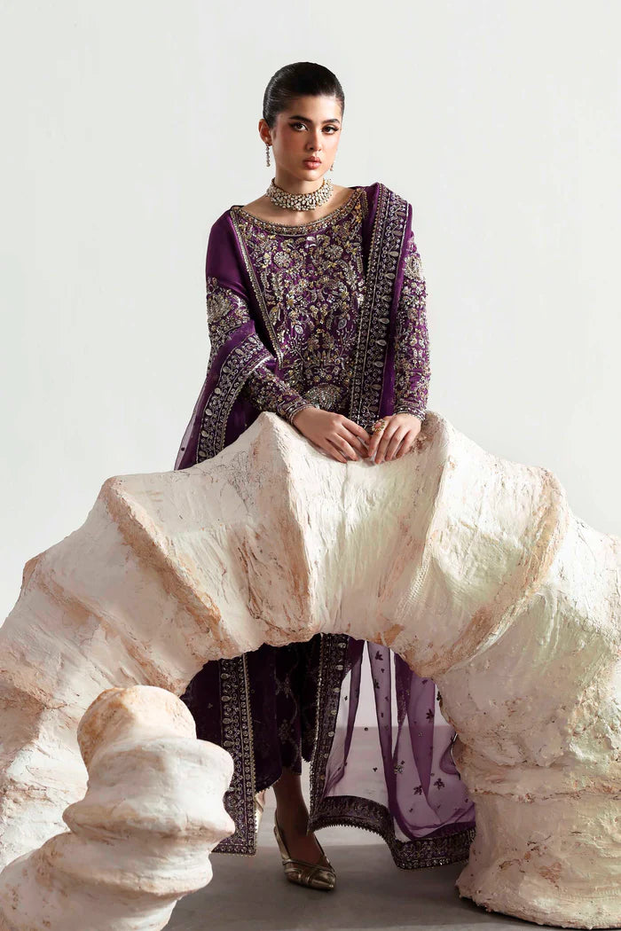 Elegant silk suit featuring hand-embellished embroidered front, dyed silk back, detailed sleeves, matching embroidered trouser, and an organza dupatta.