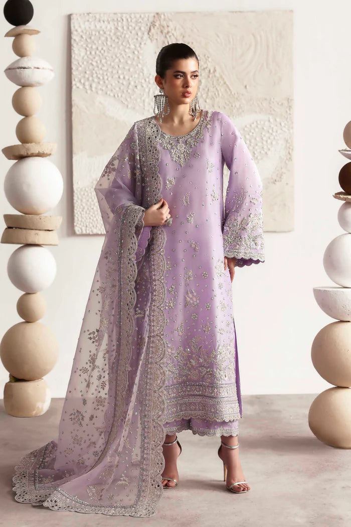 Premium silk suit featuring hand-embellished front and neckline, embroidered sleeves and borders, dyed silk back, matching trouser, and organza dupatta.