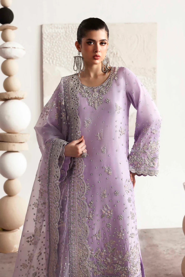 Premium silk suit featuring hand-embellished front and neckline, embroidered sleeves and borders, dyed silk back, matching trouser, and organza dupatta.