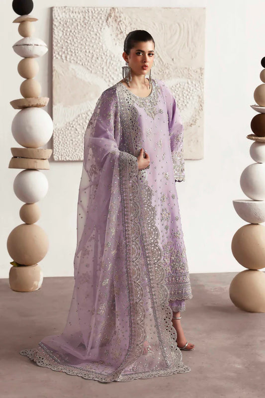 Premium silk suit featuring hand-embellished front and neckline, embroidered sleeves and borders, dyed silk back, matching trouser, and organza dupatta.