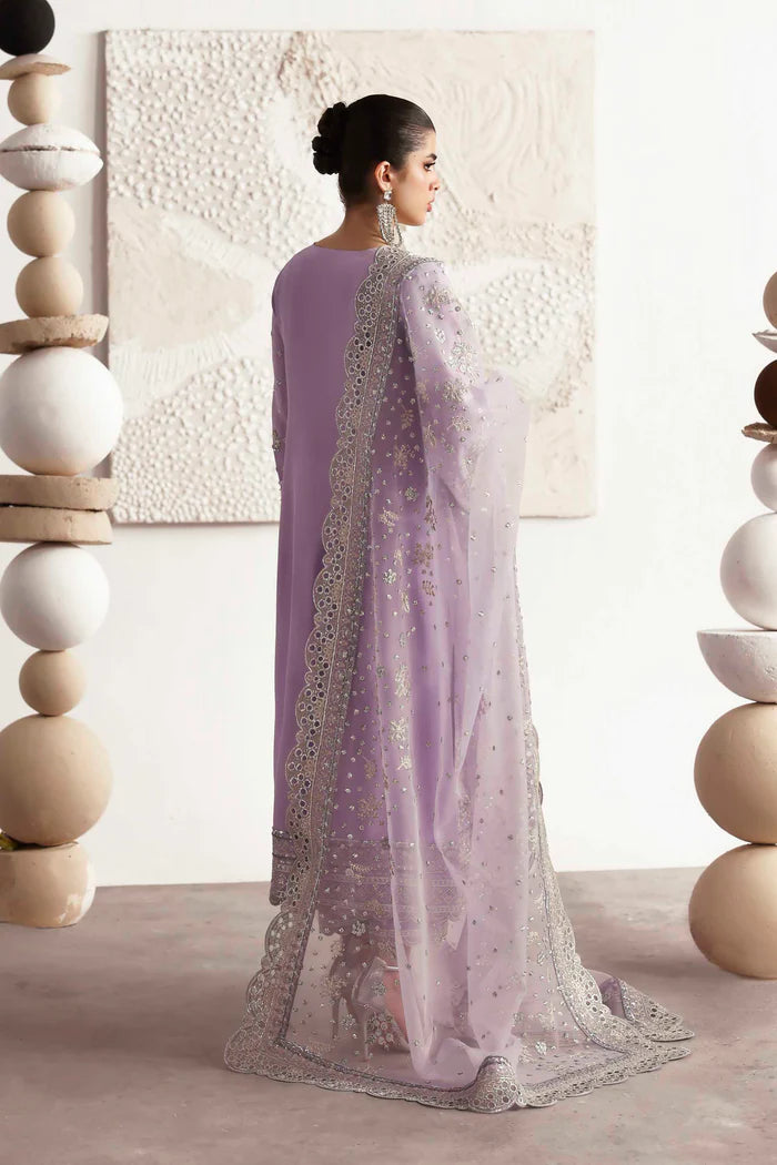 Premium silk suit featuring hand-embellished front and neckline, embroidered sleeves and borders, dyed silk back, matching trouser, and organza dupatta.