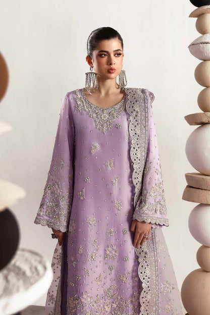 Premium silk suit featuring hand-embellished front and neckline, embroidered sleeves and borders, dyed silk back, matching trouser, and organza dupatta.