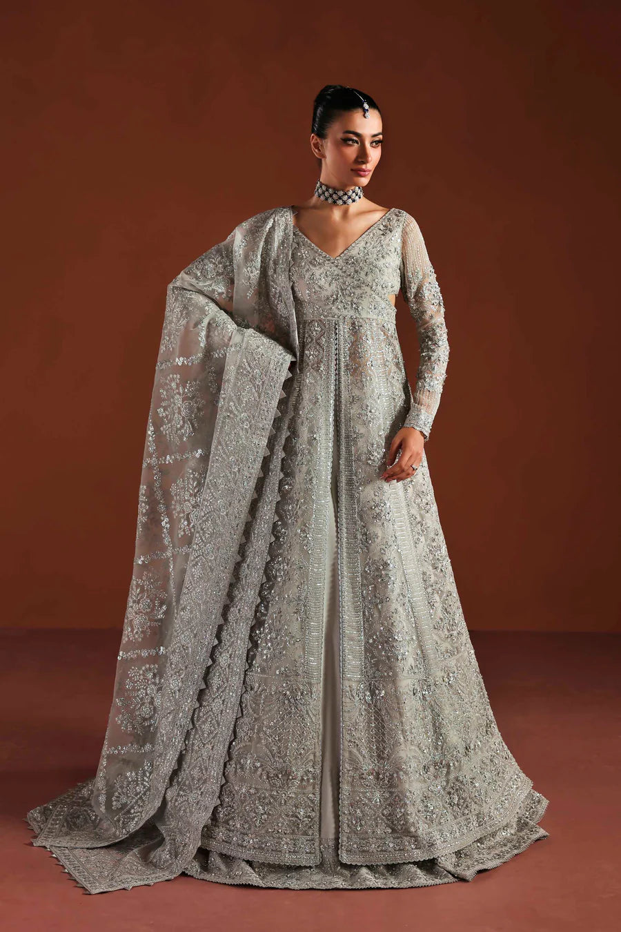Shop luxury organza embroidered lehenga with hand embellished blouse, panels & dupatta. Includes raw silk lehenga & lining—perfect for weddings.
