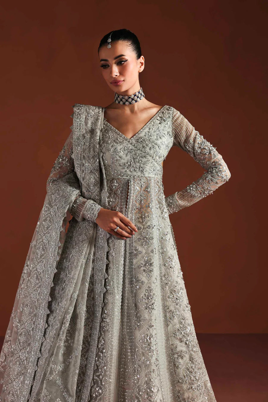 Shop luxury organza embroidered lehenga with hand embellished blouse, panels & dupatta. Includes raw silk lehenga & lining—perfect for weddings.