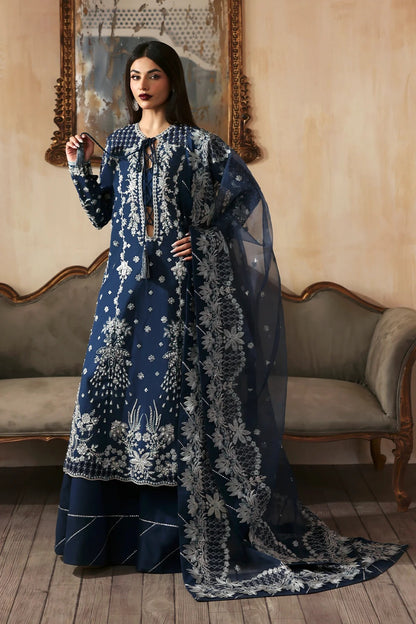 Luxury hand-embroidered raw silk suit with detailed front, back, and sleeves panels, paired with an elegant organza dupatta and matching dyed silk trousers—perfect for festive occasions.