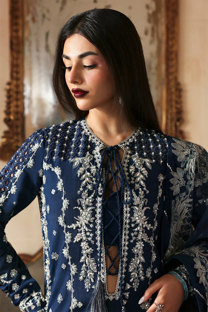 Luxury hand-embroidered raw silk suit with detailed front, back, and sleeves panels, paired with an elegant organza dupatta and matching dyed silk trousers—perfect for festive occasions.