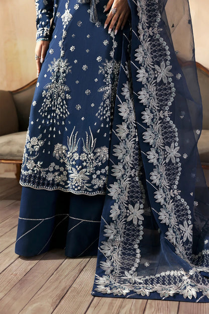 Luxury hand-embroidered raw silk suit with detailed front, back, and sleeves panels, paired with an elegant organza dupatta and matching dyed silk trousers—perfect for festive occasions.