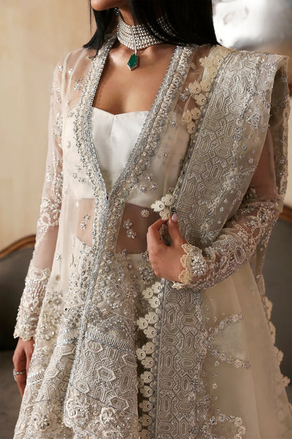 Luxurious handmade organza suit featuring embroidered front, back, and sleeves panels, paired with an elegant dupatta and zari jacquard trousers—perfect for festive occasions.