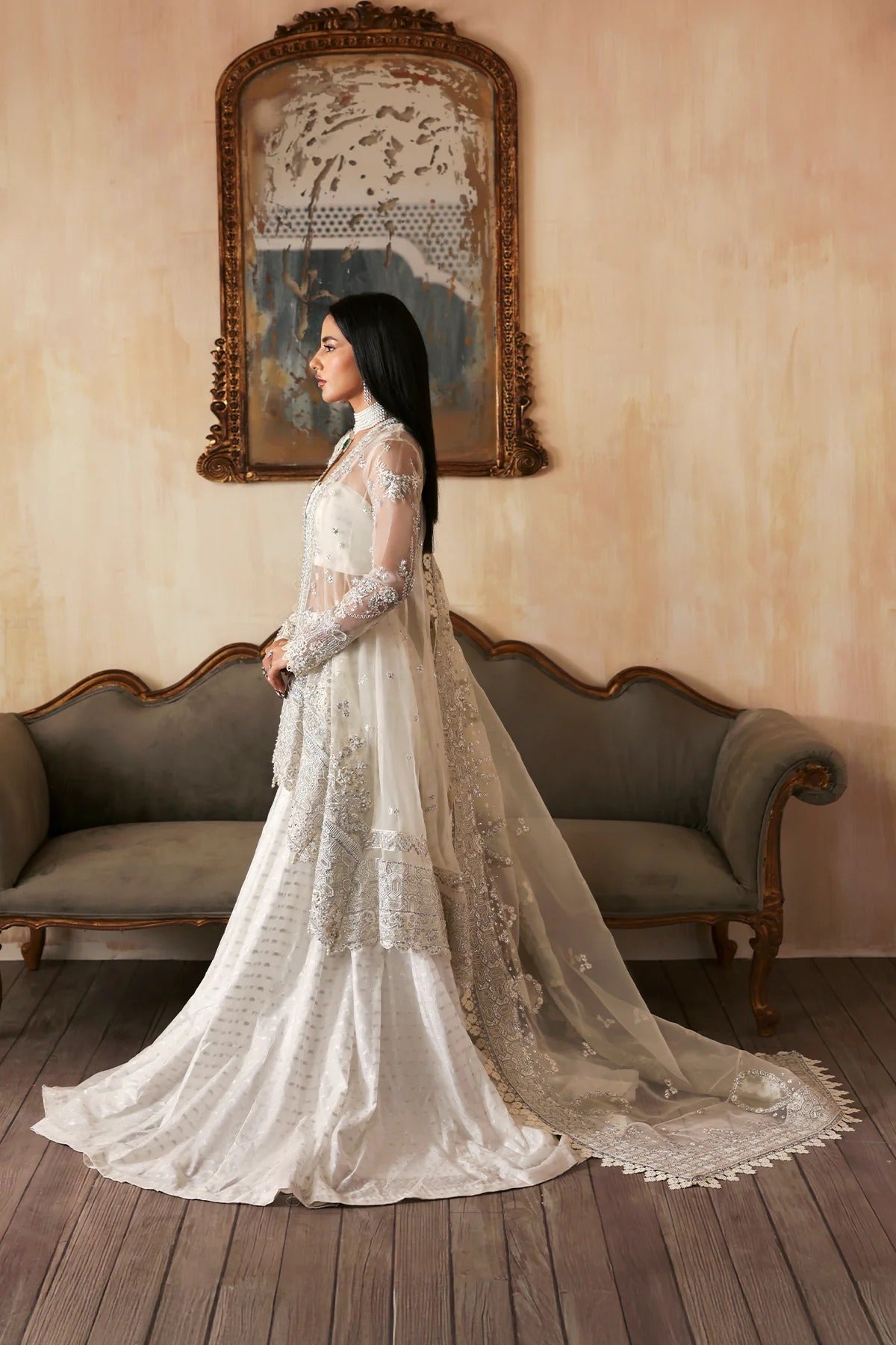 Luxurious handmade organza suit featuring embroidered front, back, and sleeves panels, paired with an elegant dupatta and zari jacquard trousers—perfect for festive occasions.