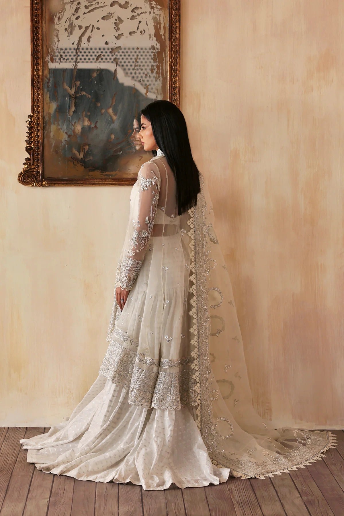 Luxurious handmade organza suit featuring embroidered front, back, and sleeves panels, paired with an elegant dupatta and zari jacquard trousers—perfect for festive occasions.