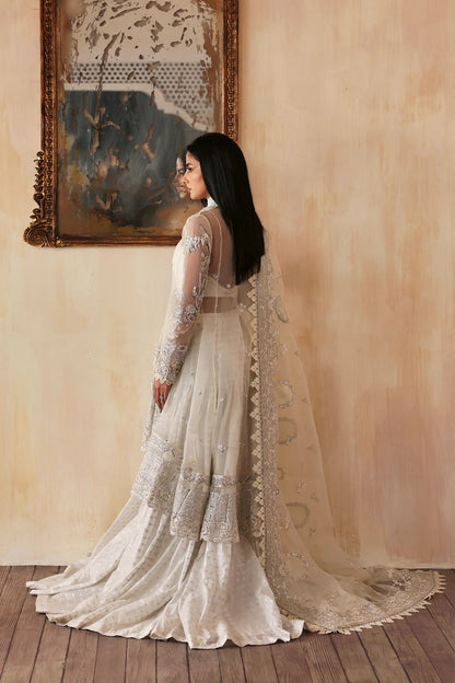 Luxurious handmade organza suit featuring embroidered front, back, and sleeves panels, paired with an elegant dupatta and zari jacquard trousers—perfect for festive occasions.