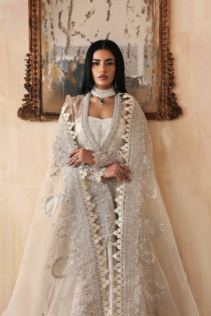 Luxurious handmade organza suit featuring embroidered front, back, and sleeves panels, paired with an elegant dupatta and zari jacquard trousers—perfect for festive occasions.