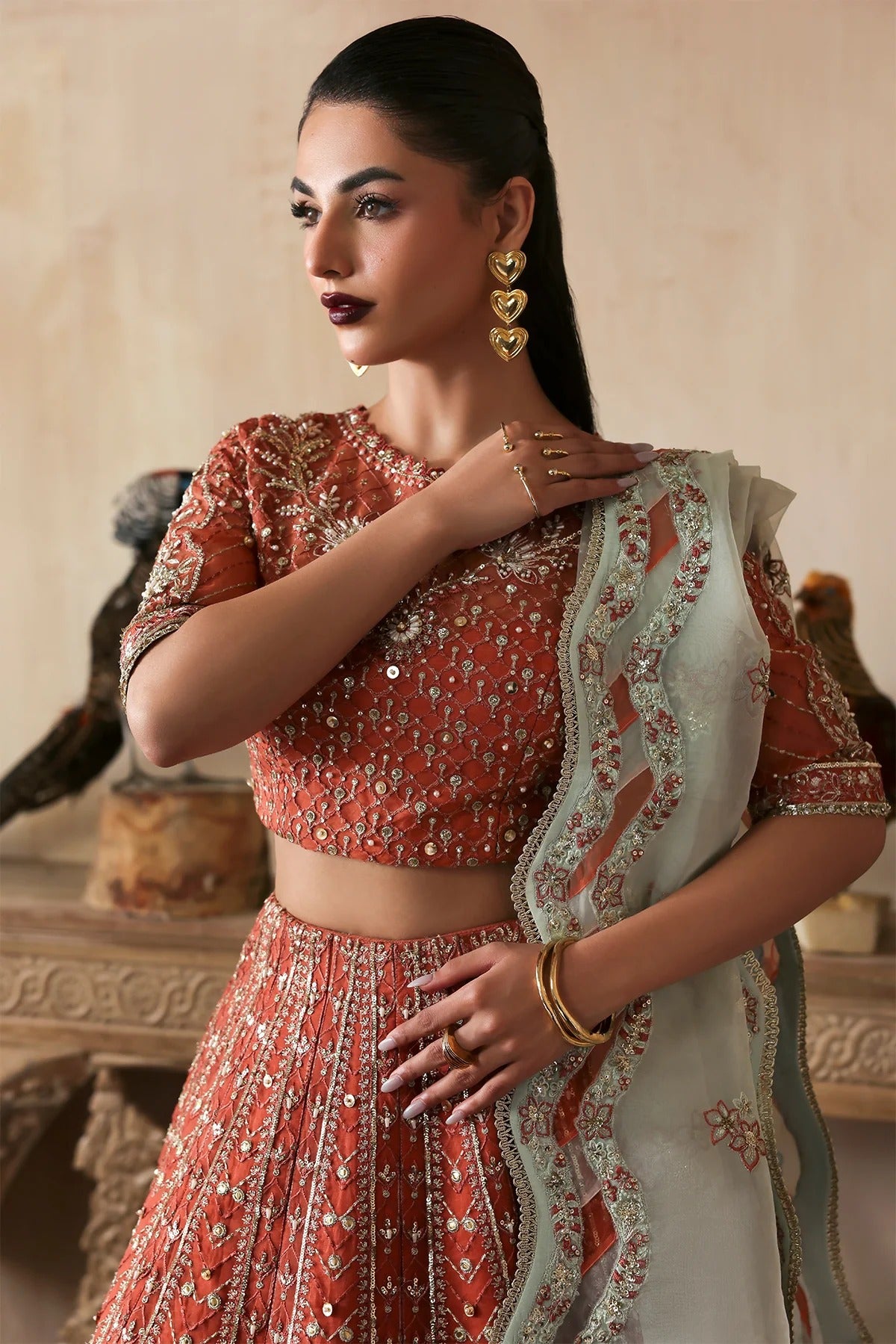Elegant hand-embroidered organza suit with detailed front, back, and sleeves panels, complemented by an embroidered organza dupatta—perfect for festive and formal occasions.