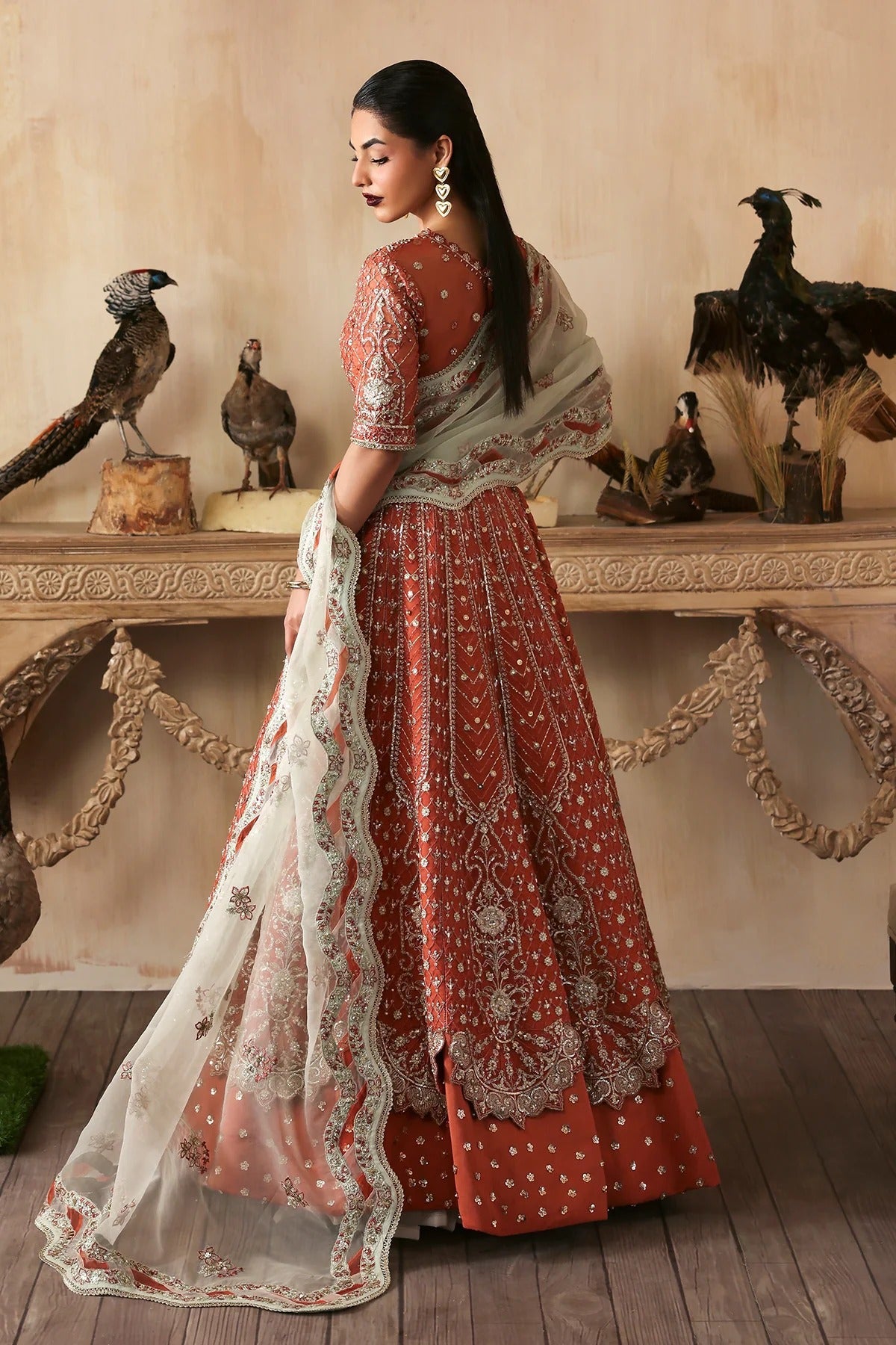 Elegant hand-embroidered organza suit with detailed front, back, and sleeves panels, complemented by an embroidered organza dupatta—perfect for festive and formal occasions.