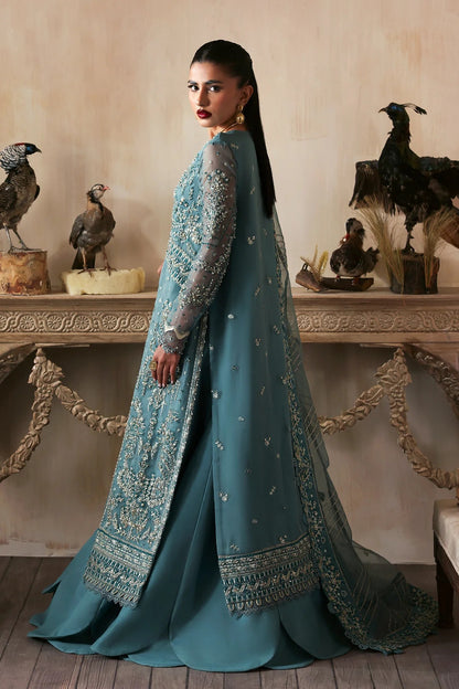 Elegant hand-embroidered organza suit with detailed front, back, and sleeves panels, paired with an embroidered organza dupatta and dyed trousers—perfect for festive occasions.