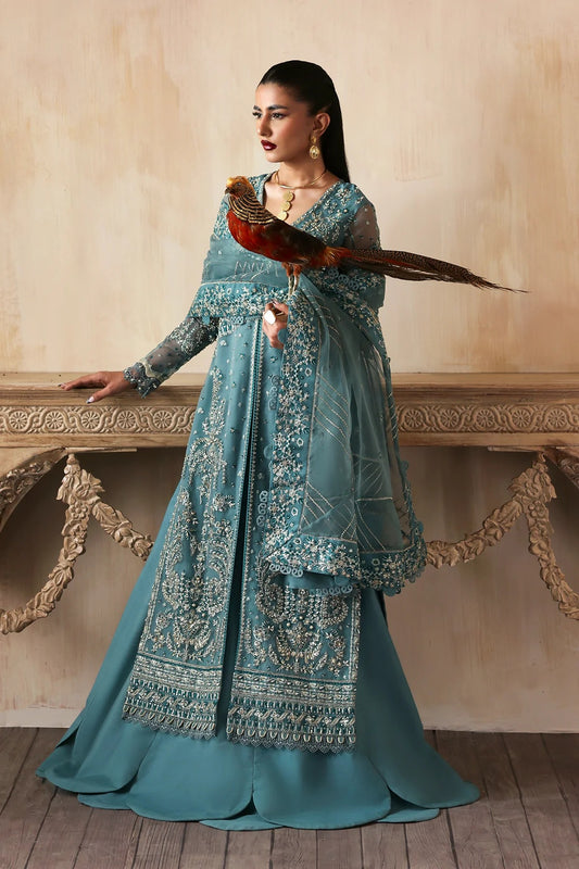 Elegant hand-embroidered organza suit with detailed front, back, and sleeves panels, paired with an embroidered organza dupatta and dyed trousers—perfect for festive occasions.