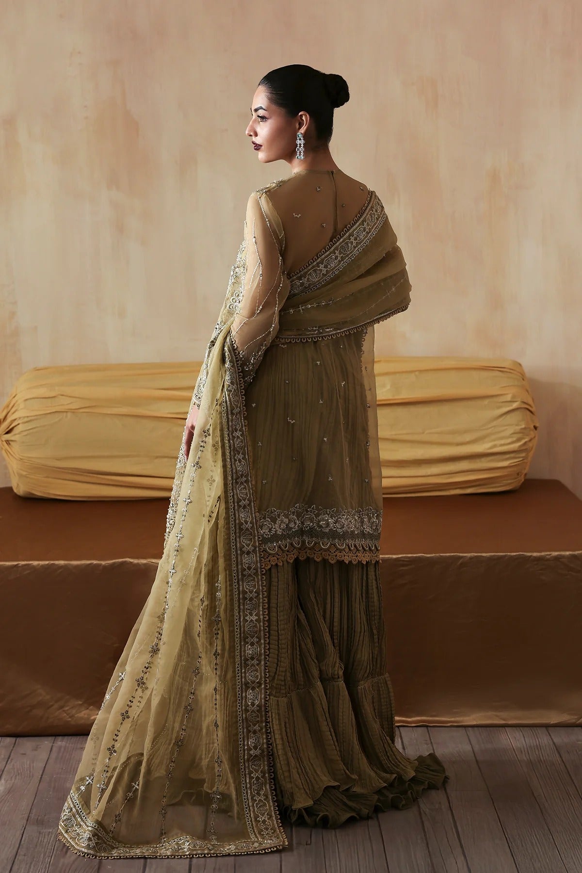 Exquisite hand-embroidered organza suit featuring detailed front, back, and sleeves panels, paired with an embroidered organza dupatta and dyed trousers for festive elegance.