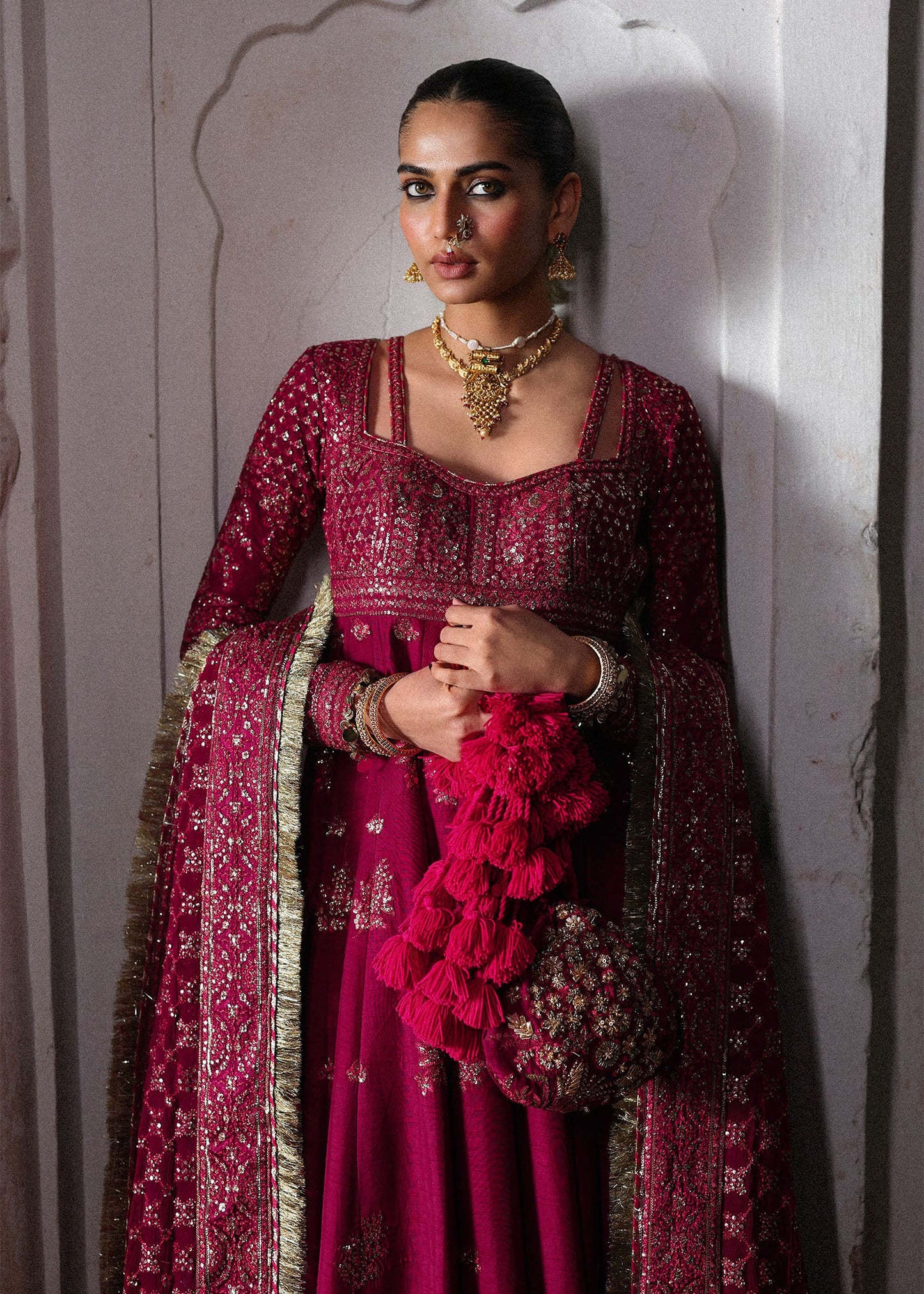 Elegant hot pink embroidered pishwas with detailed panels, Korean raw silk chooridar and a chiffon dupatta featuring all-over jaal and four sided borders.