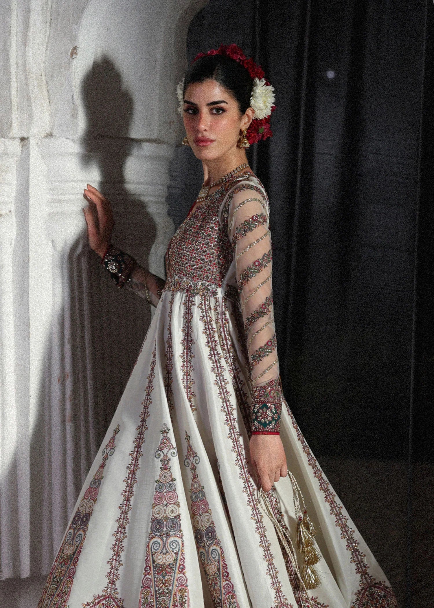 Elegant ivory embroidered pishwas with detailed panels, net sleeves, printed Korean raw silk chooridar and an embroidered Korean silk shawl for formal events.