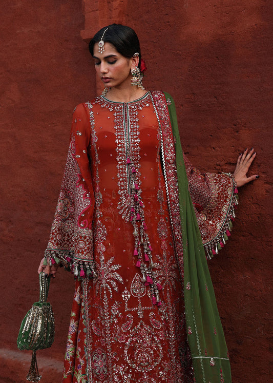 Sophisticated rust chiffon suit with intricate embroidery, bordered sleeves, Korean raw silk sharara and an embroidered chiffon dupatta with four sided borders.