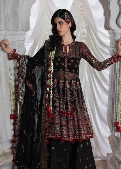 Elegant black embroidered peplum paired with flared Korean raw silk sharara and chiffon dupatta featuring delicate embroidery and four-sided borders for festive events.