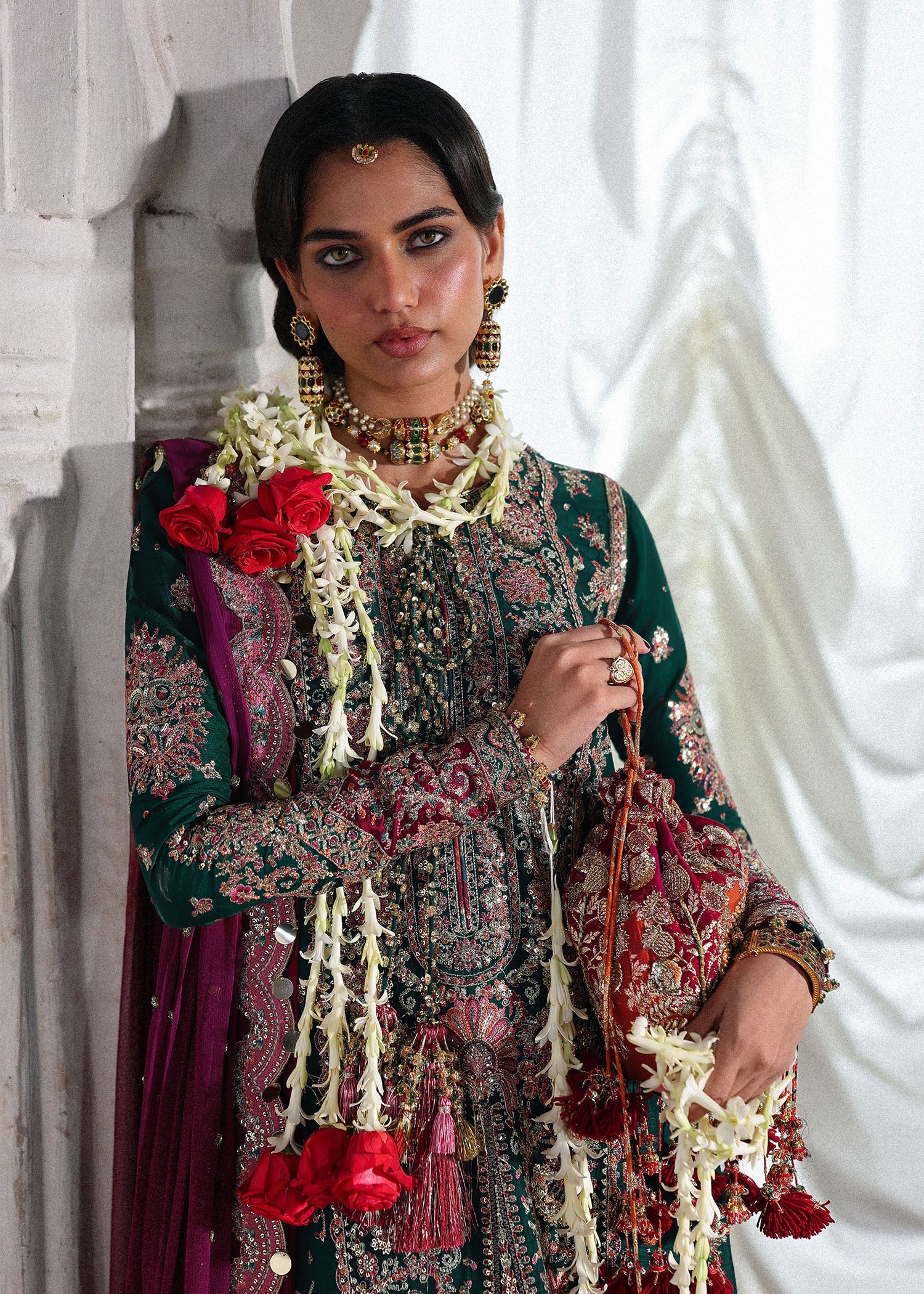 Elegant emerald green Korean raw silk suit with five panel embroidered shirt, printed chooridar and a chiffon dupatta featuring pallu and four sided borders.