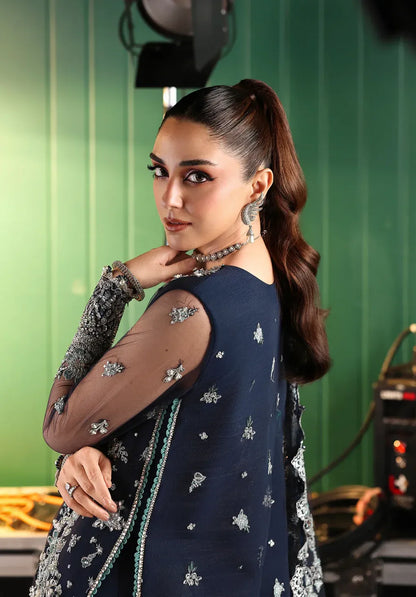 Skyfall by Elaf Stardom ’25 features hand-embroidered poly-net panels, detailed dupatta, and raw silk inner — perfect for formal evenings and festive elegance.