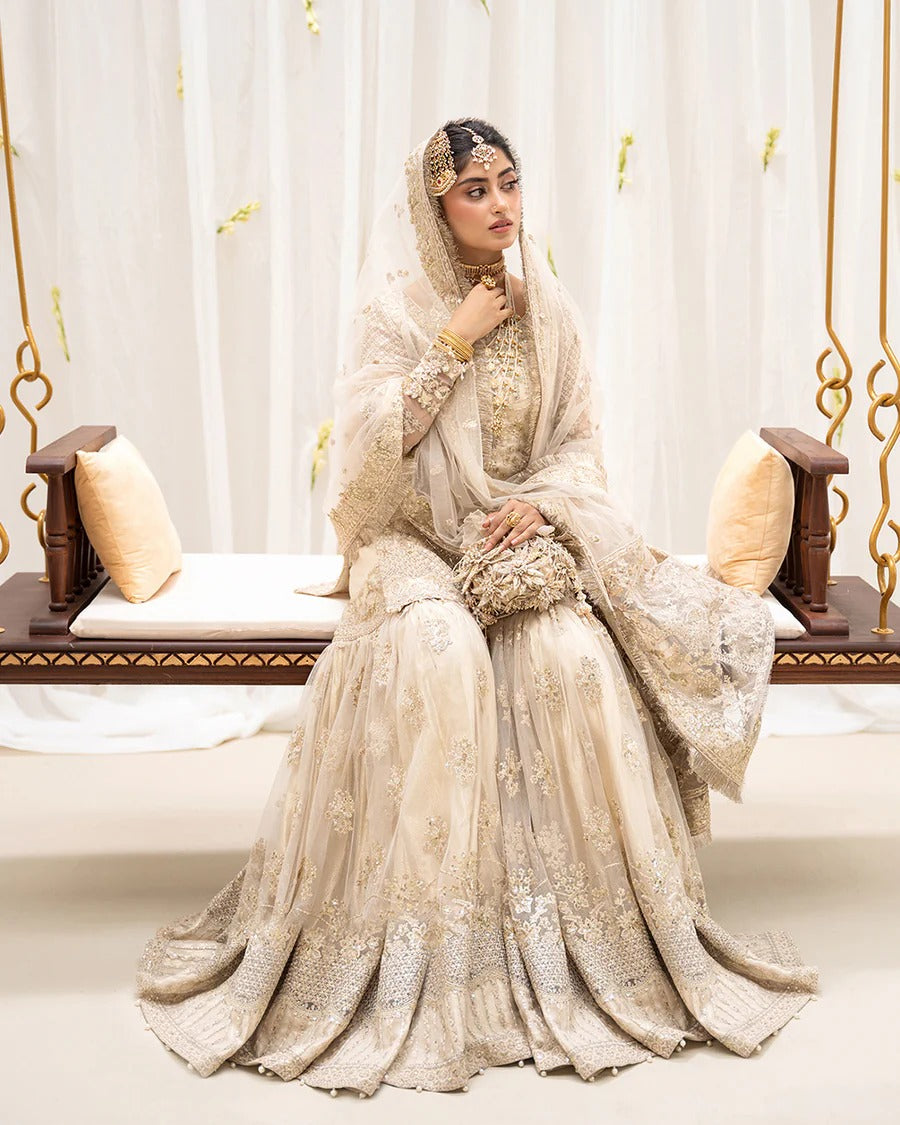 Safak ivory net gharara set with gold embroidery, featuring detailed shirt panels, embroidered dupatta, and gharara—perfect for weddings and festive celebrations.