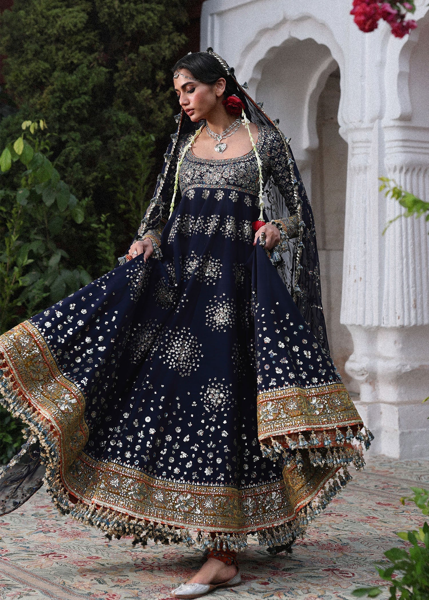 Elegant navy blue Korean raw silk pishwas with embroidered panels and sleeves, paired with printed chooridar and chiffon dupatta with four-sided borders.